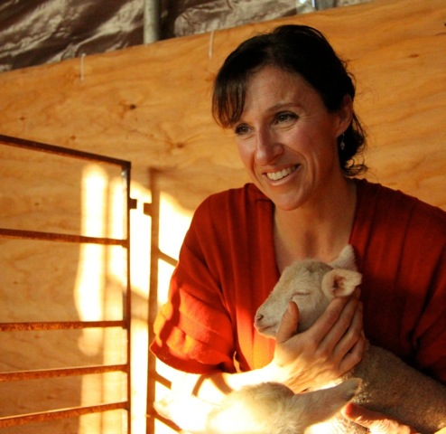 Female holding baby goat