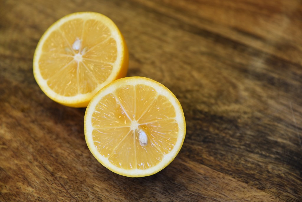 Meyer lemons cut in half on cutting board