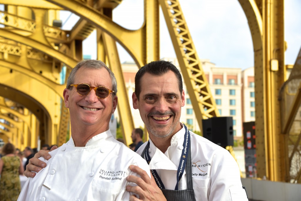Two chefs in front of yellow bridge