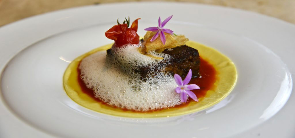 Quinto Quarto with Pave of Braised Oxtail, Heirloom Tomato “Sugo”, Egg Yolk Pasta, Crispy Garlic and Parmesan